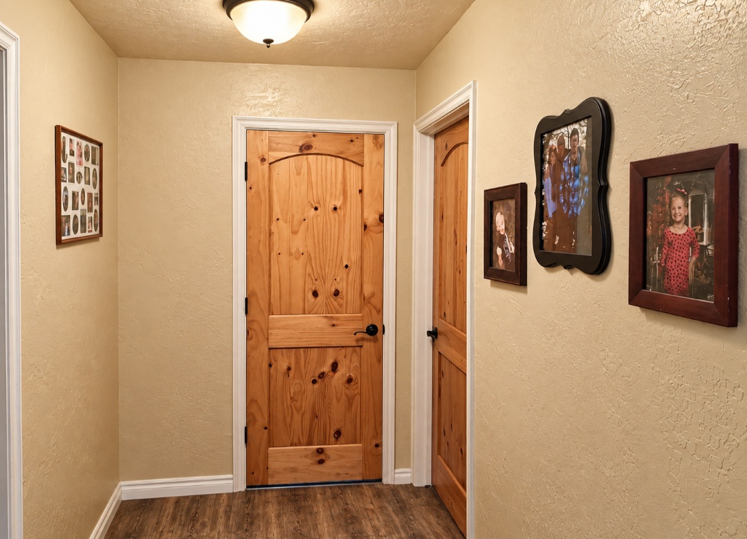 12526 3520th Road Seminole, OK 74868 - Photo 19 of 42 Hallway featuring warm textured walls, wood-finish doors with traditional hardware, wood-finish flooring, and recessed ceiling lighting