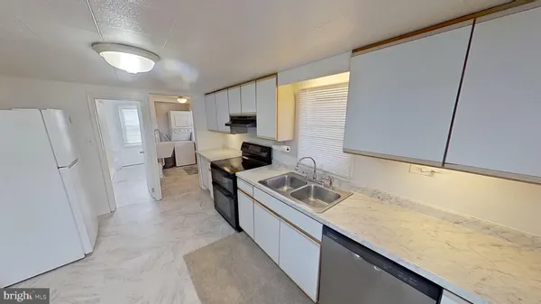 a kitchen with refrigerator and cabinets