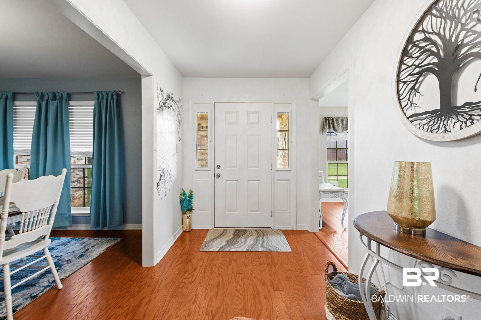 16151 Tolbert Road Bay Minette, AL 36507 - Photo 3 of 74 Entryway featuring wood-finish flooring, a white paneled front door with sidelight windows.