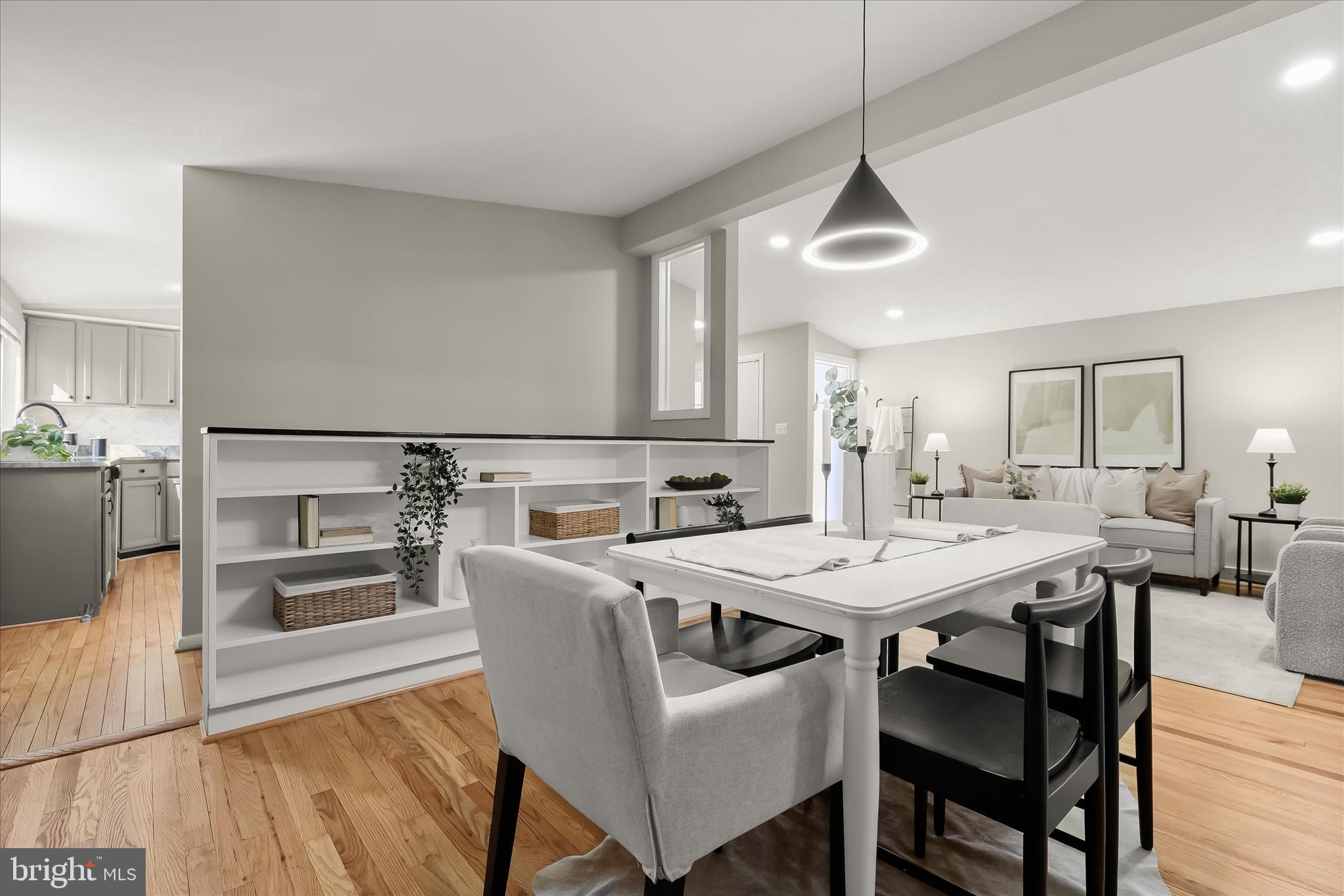 1009 Flagtree Lane Baltimore, MD 21208 - Photo 23 of 61 a kitchen with stainless steel appliances granite countertop a stove a refrigerator a dining table and chairs with wooden floor