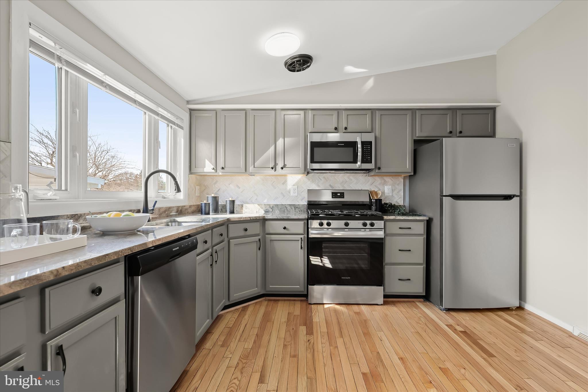 1009 Flagtree Lane Baltimore, MD 21208 - Photo 24 of 61 a kitchen with kitchen island granite countertop a sink stainless steel appliances and counter space