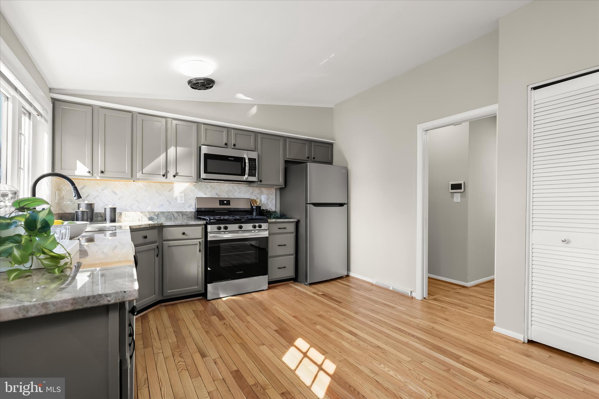 1009 Flagtree Lane Baltimore, MD 21208 - Photo 25 of 61 a kitchen with granite countertop stainless steel appliances and wooden cabinets