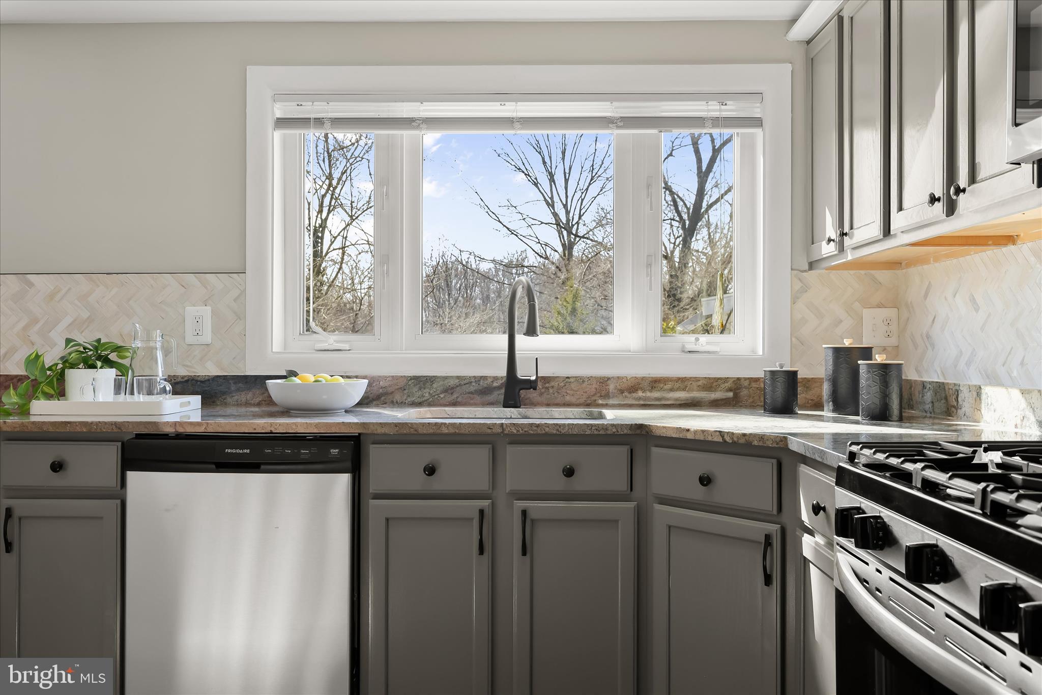 1009 Flagtree Lane Baltimore, MD 21208 - Photo 26 of 61 a kitchen with granite countertop a sink a window and appliances