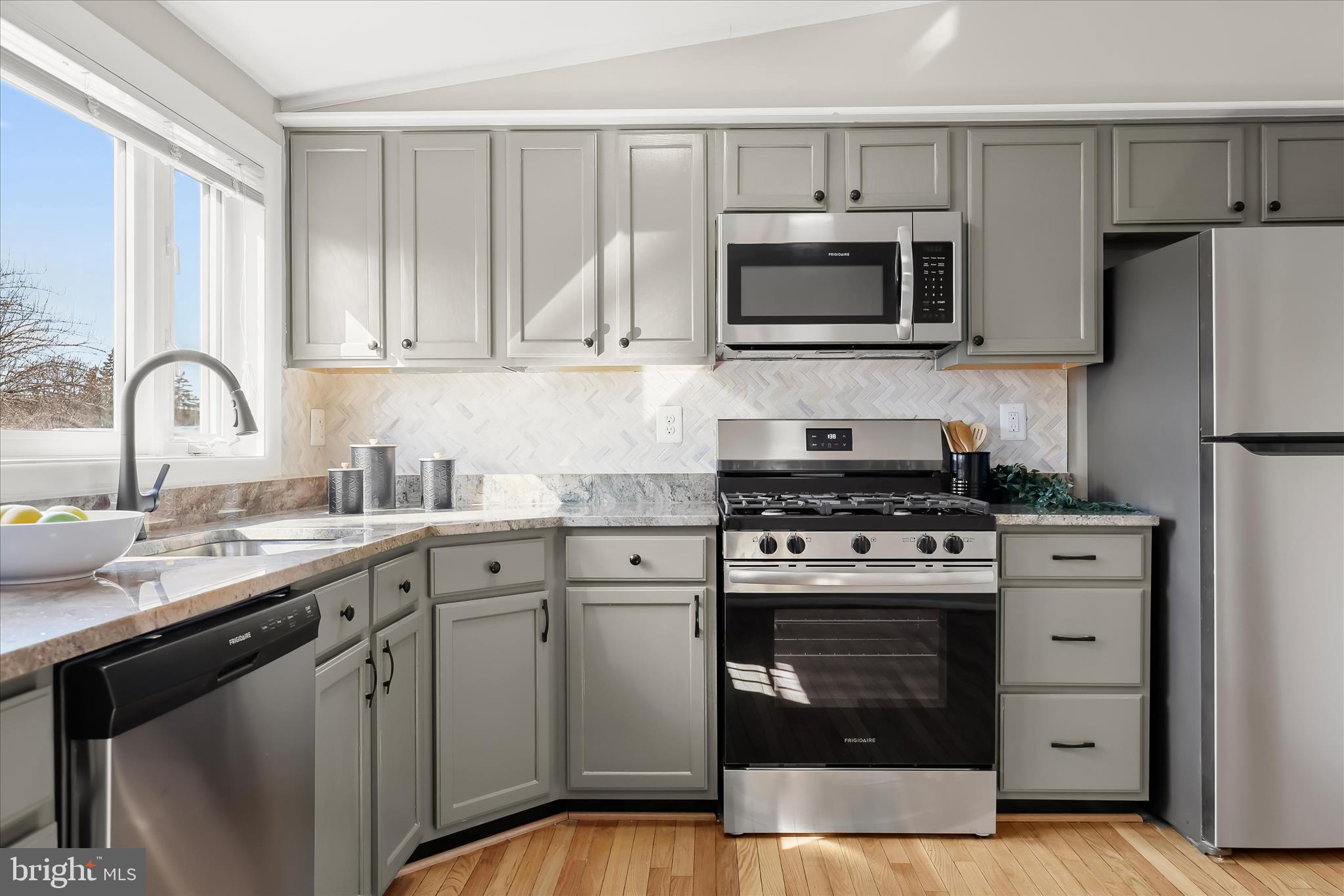 1009 Flagtree Lane Baltimore, MD 21208 - Photo 27 of 61 a kitchen with stainless steel appliances granite countertop a stove a sink and a microwave