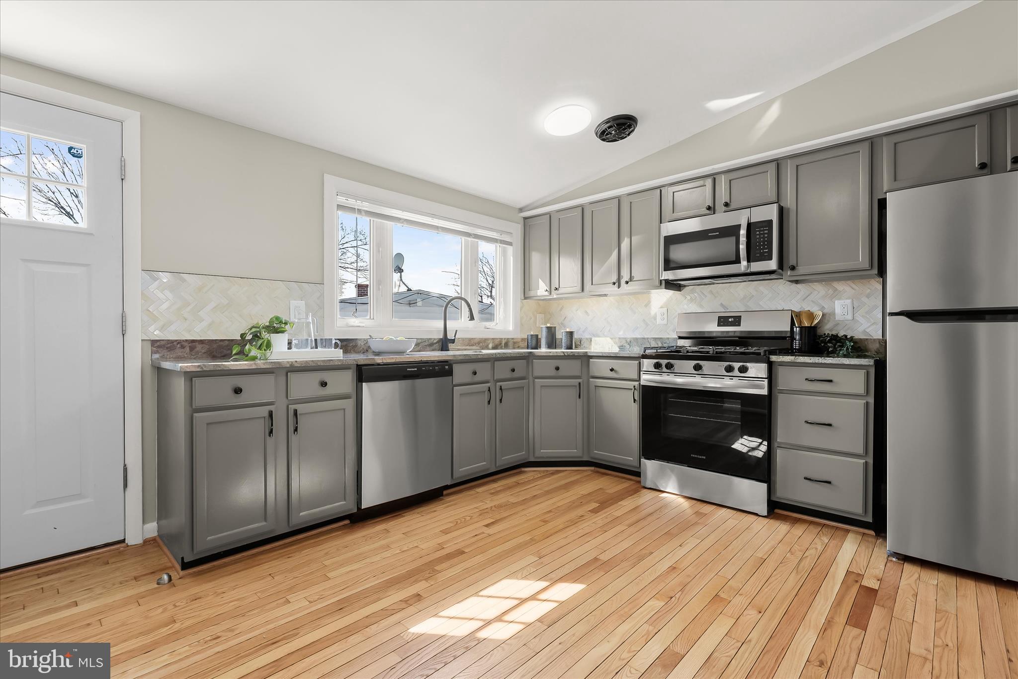 1009 Flagtree Lane Baltimore, MD 21208 - Photo 29 of 61 a kitchen with stainless steel appliances a refrigerator sink and cabinets