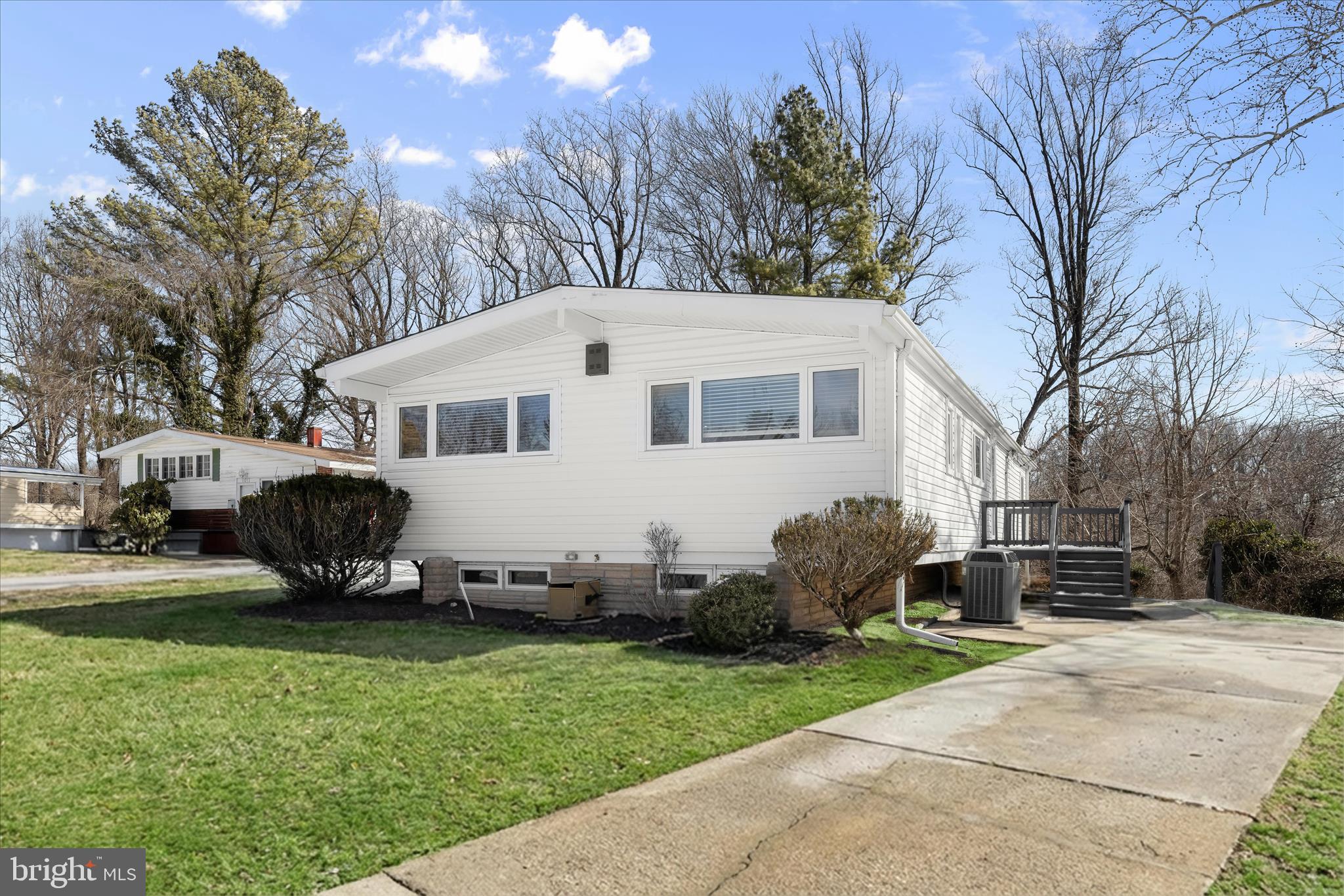 1009 Flagtree Lane Baltimore, MD 21208 - Photo 4 of 61 a view of a white house with a yard and a garden