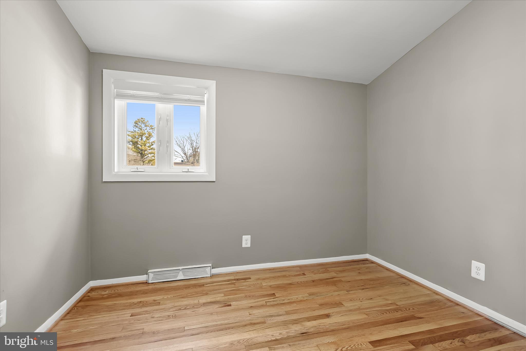 1009 Flagtree Lane Baltimore, MD 21208 - Photo 44 of 61 a view of an empty room with wooden floor and a window