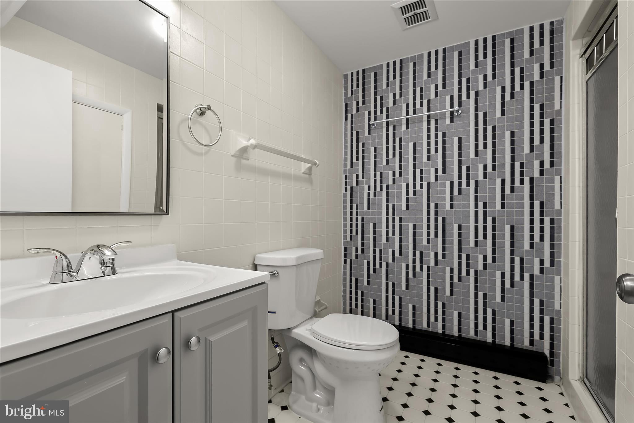 1009 Flagtree Lane Baltimore, MD 21208 - Photo 53 of 61 a bathroom with a sink a toilet and shower