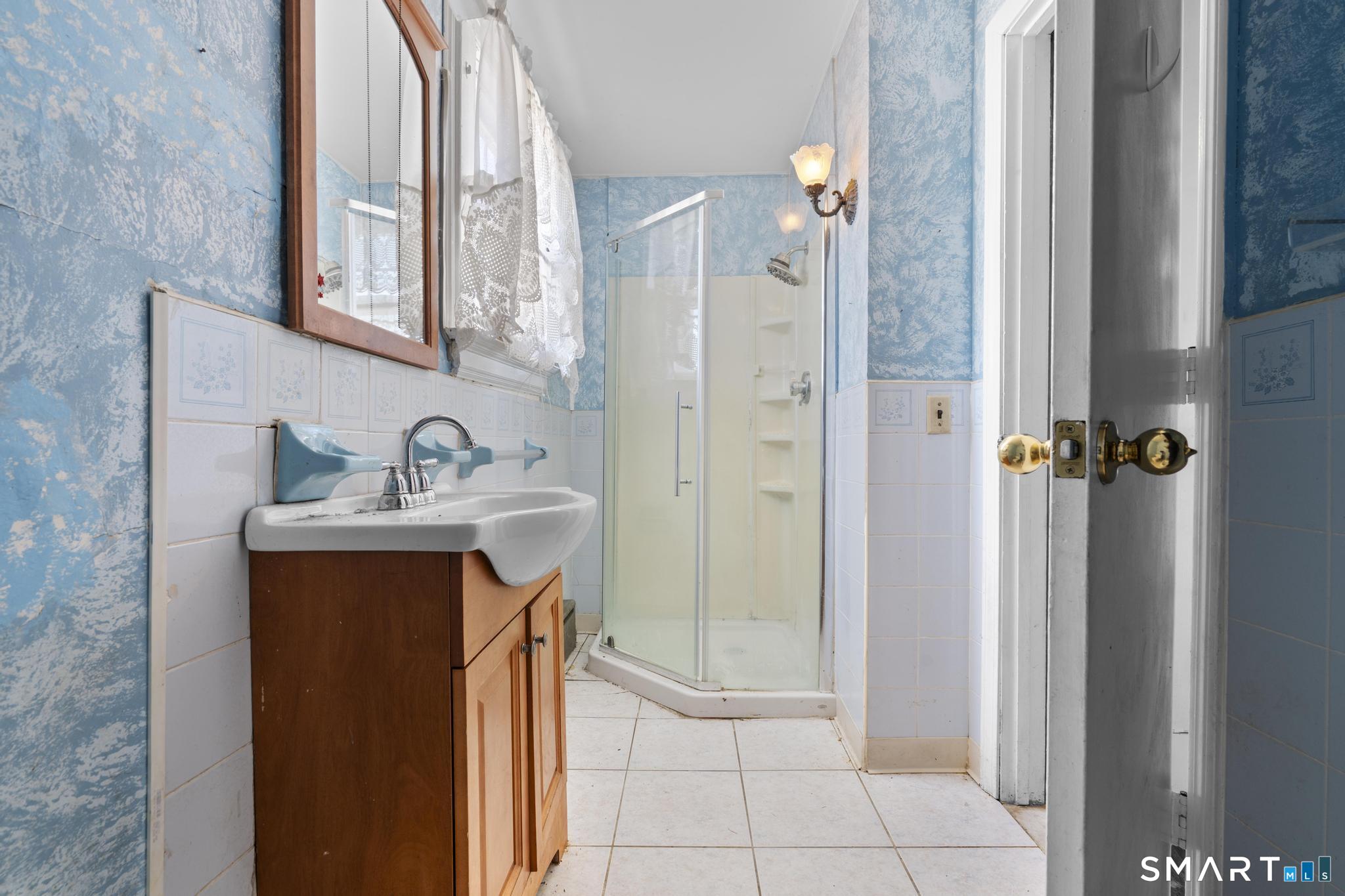 4 Fairview Terrace Derby, CT 06418 - Photo 18 of 34 a bathroom with a sink a mirror and shower
