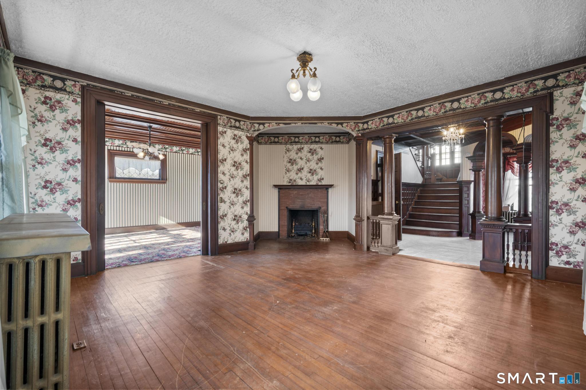 4 Fairview Terrace Derby, CT 06418 - Photo 5 of 34 a view of an empty room with wooden floor fireplace and a window