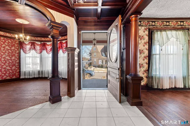 a view of entryway and hall with wooden floor