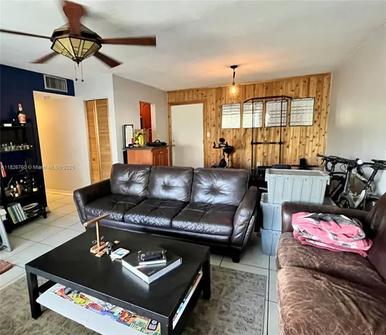 a living room with furniture a rug and a window