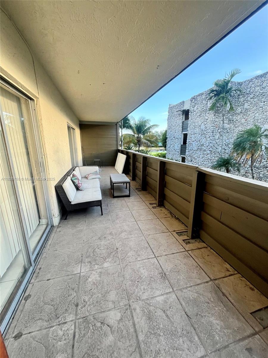 8325 Southwest 72nd Avenue, Unit 214C Miami, FL 33143 - Photo 11 of 12 a living room with furniture and a large window