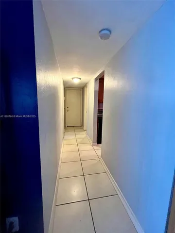 a view of hallway with a window and a mirror