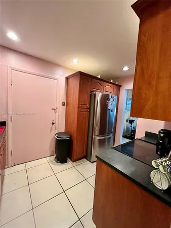 a kitchen with a sink and a refrigerator