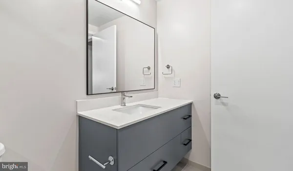 a bedroom with furniture and a large window