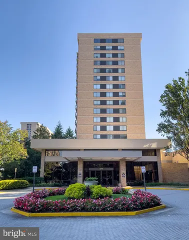 a living room with fireplace furniture and a potted plant