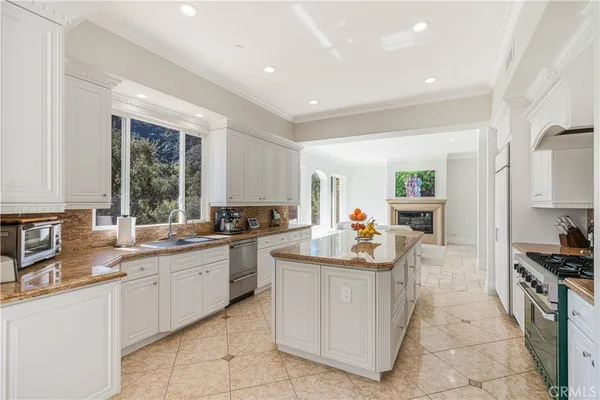 a kitchen with sink a stove and cabinets