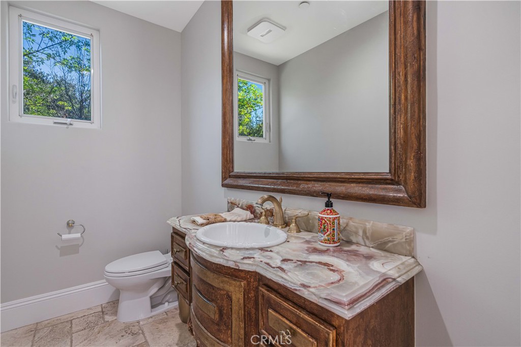 11 Baymare Road Bell Canyon, CA 91307 - Photo 21 of 39 a bathroom with a granite countertop toilet sink and mirror