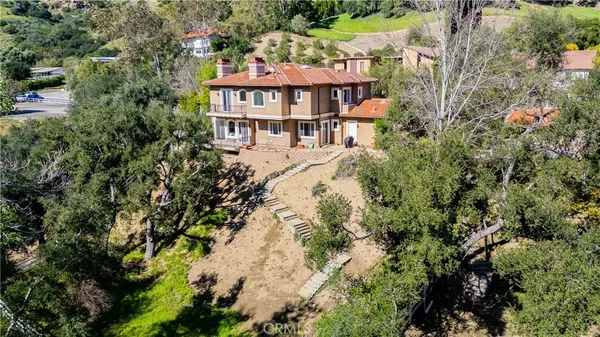 an aerial view of a house with a yard