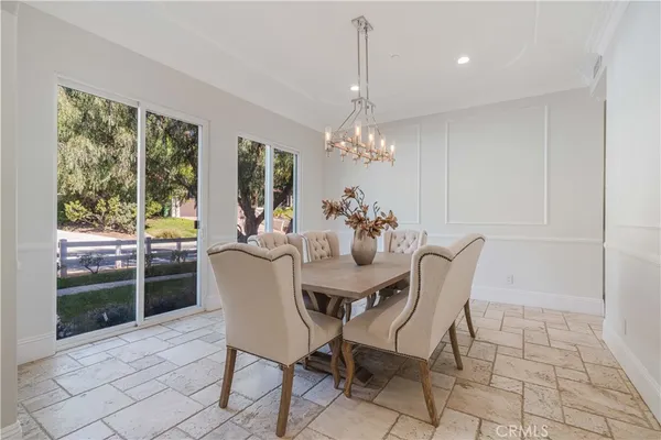 a dining room with furniture a chandelier and window
