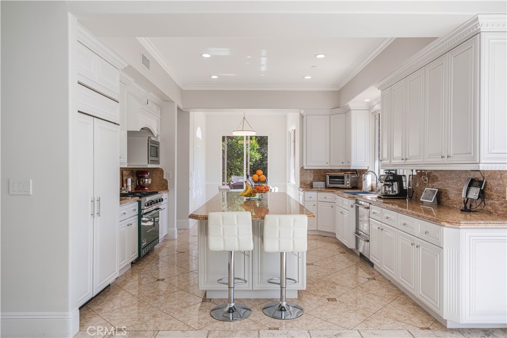 11 Baymare Road Bell Canyon, CA 91307 - Photo 10 of 39 a view of a kitchen with kitchen island granite countertop lots of counter top space and stainless steel appliances