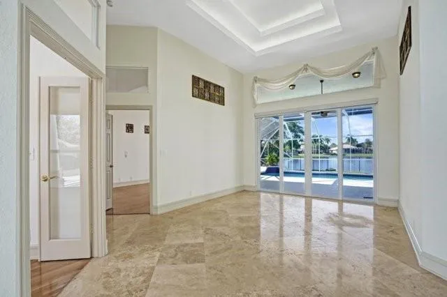 a view of a big room with wooden floor and windows