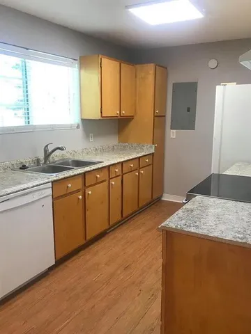 a kitchen with stainless steel appliances granite countertop a sink stove and cabinets