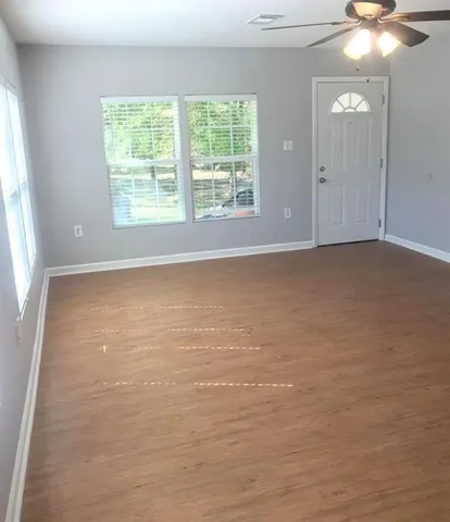 an empty room with windows and closet