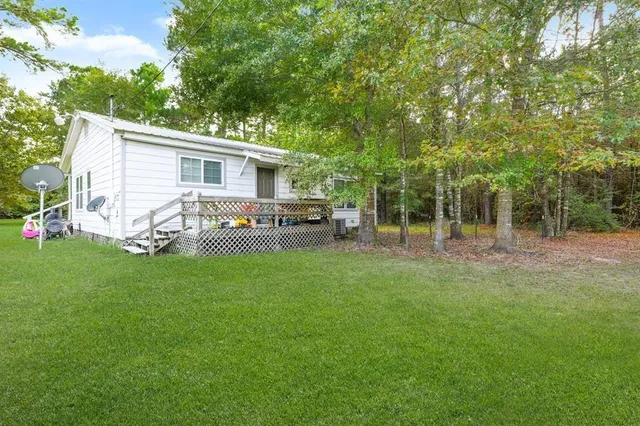 a view of a house with backyard and sitting area