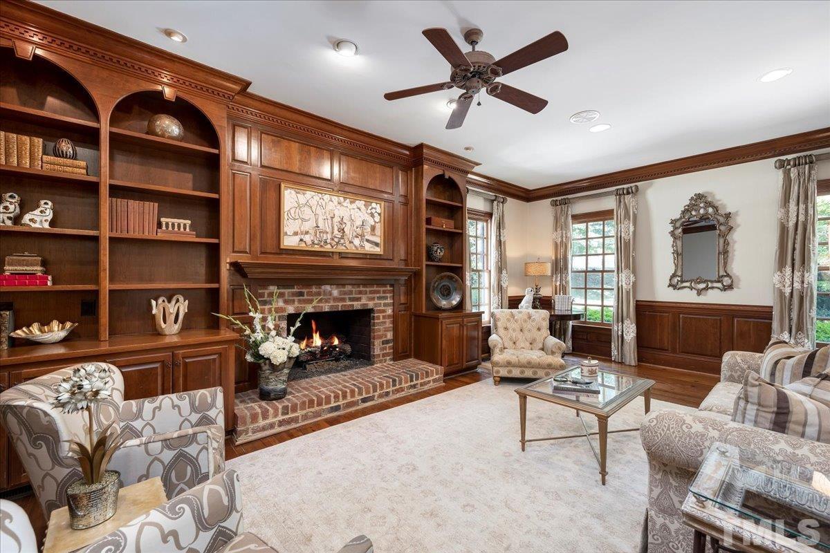 1213 Marlowe Road Raleigh, NC 27609 - Photo 11 of 30 a living room with furniture a fireplace and a large window
