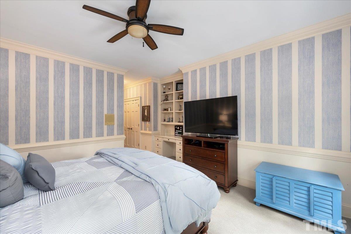 1213 Marlowe Road Raleigh, NC 27609 - Photo 22 of 30 a bedroom with a bed and a flat screen tv