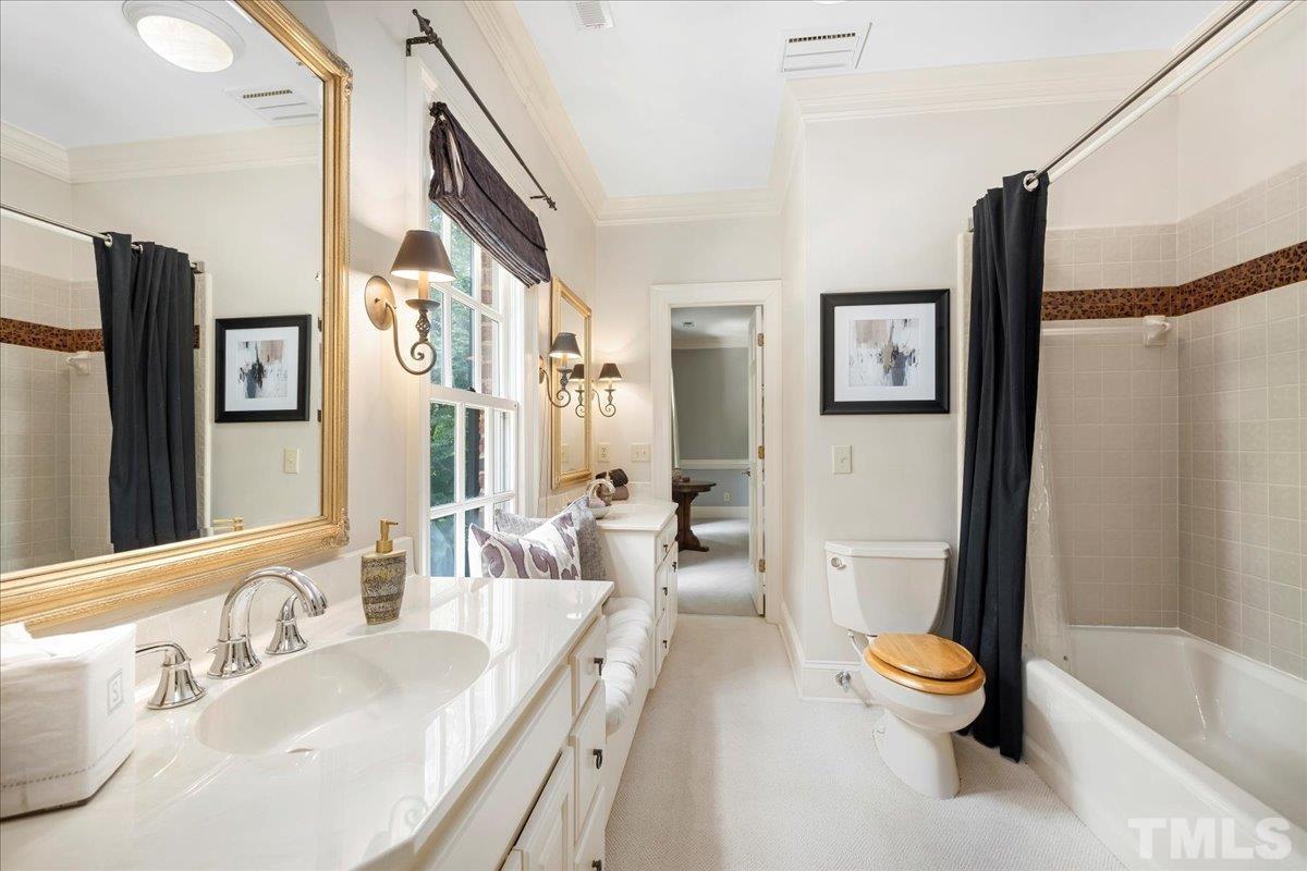 1213 Marlowe Road Raleigh, NC 27609 - Photo 25 of 30 a bathroom with a granite countertop sink and a large mirror