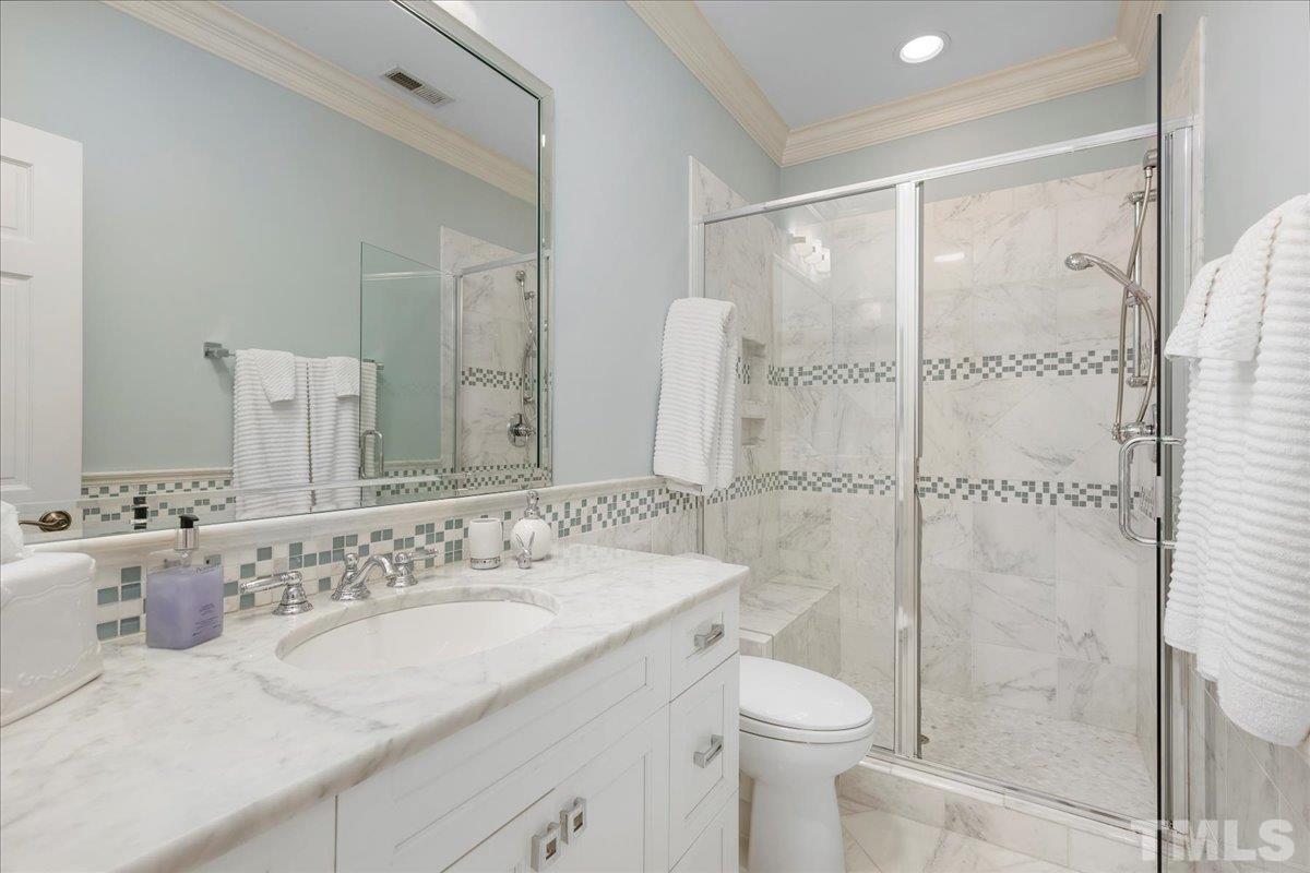 1213 Marlowe Road Raleigh, NC 27609 - Photo 29 of 30 a bathroom with a granite countertop sink toilet and shower