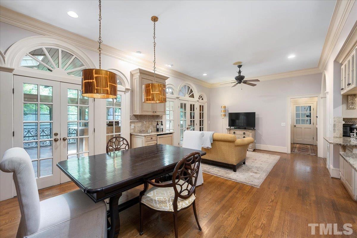 1213 Marlowe Road Raleigh, NC 27609 - Photo 7 of 30 a dining room with furniture wooden floor a rug a potted plant and a chandelier