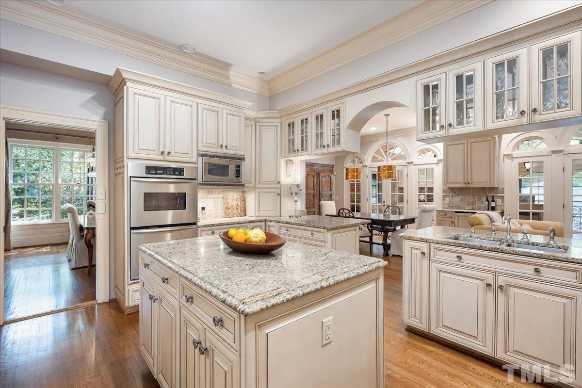 1213 Marlowe Road Raleigh, NC 27609 - Photo 9 of 30 a kitchen with stainless steel appliances granite countertop a sink and cabinets
