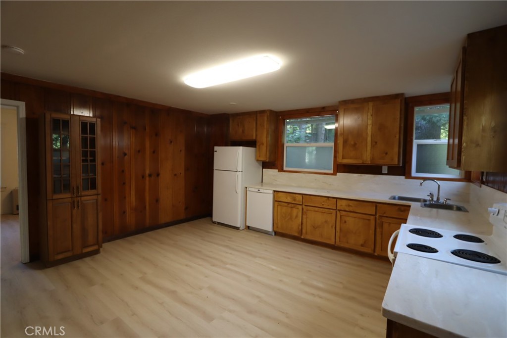 10466 Redwood Road Middletown, CA 95461 - Photo 4 of 14 a kitchen with a refrigerator a sink and cabinets