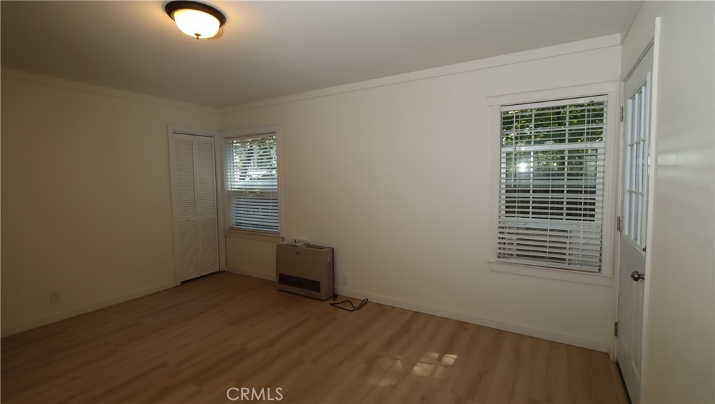 10466 Redwood Road Middletown, CA 95461 - Photo 9 of 14 an empty room with wooden floor and windows
