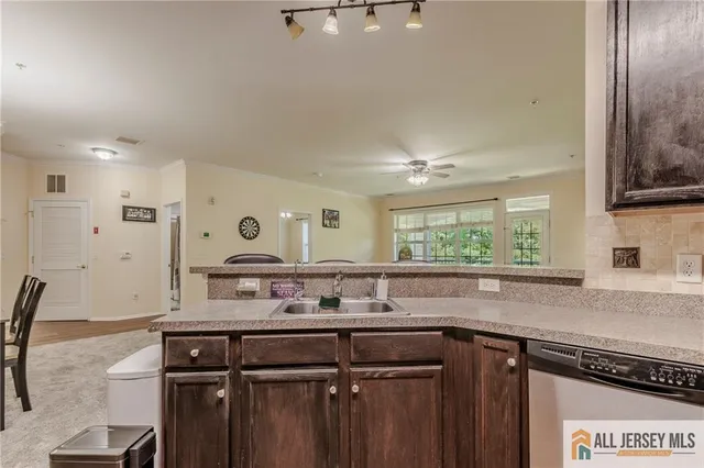 a kitchen with a sink cabinets and window