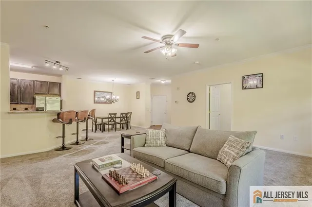 a living room with furniture and kitchen view