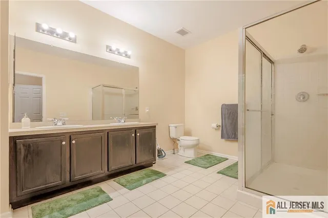 a bathroom with a sink a mirror and a shower