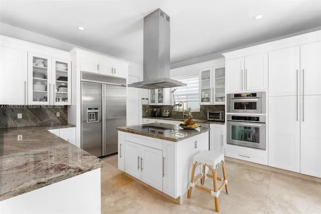 a kitchen with granite countertop a sink and a stove top oven