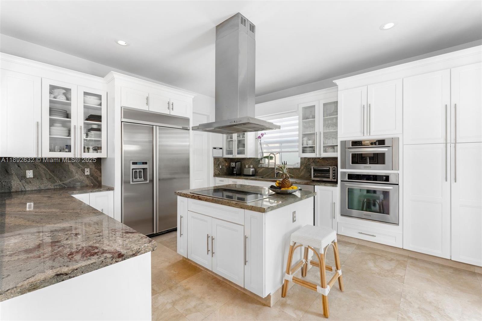 2143 North Bay Road Miami Beach, FL 33140 - Photo 11 of 39 a kitchen with stainless steel appliances granite countertop a stove refrigerator and microwave