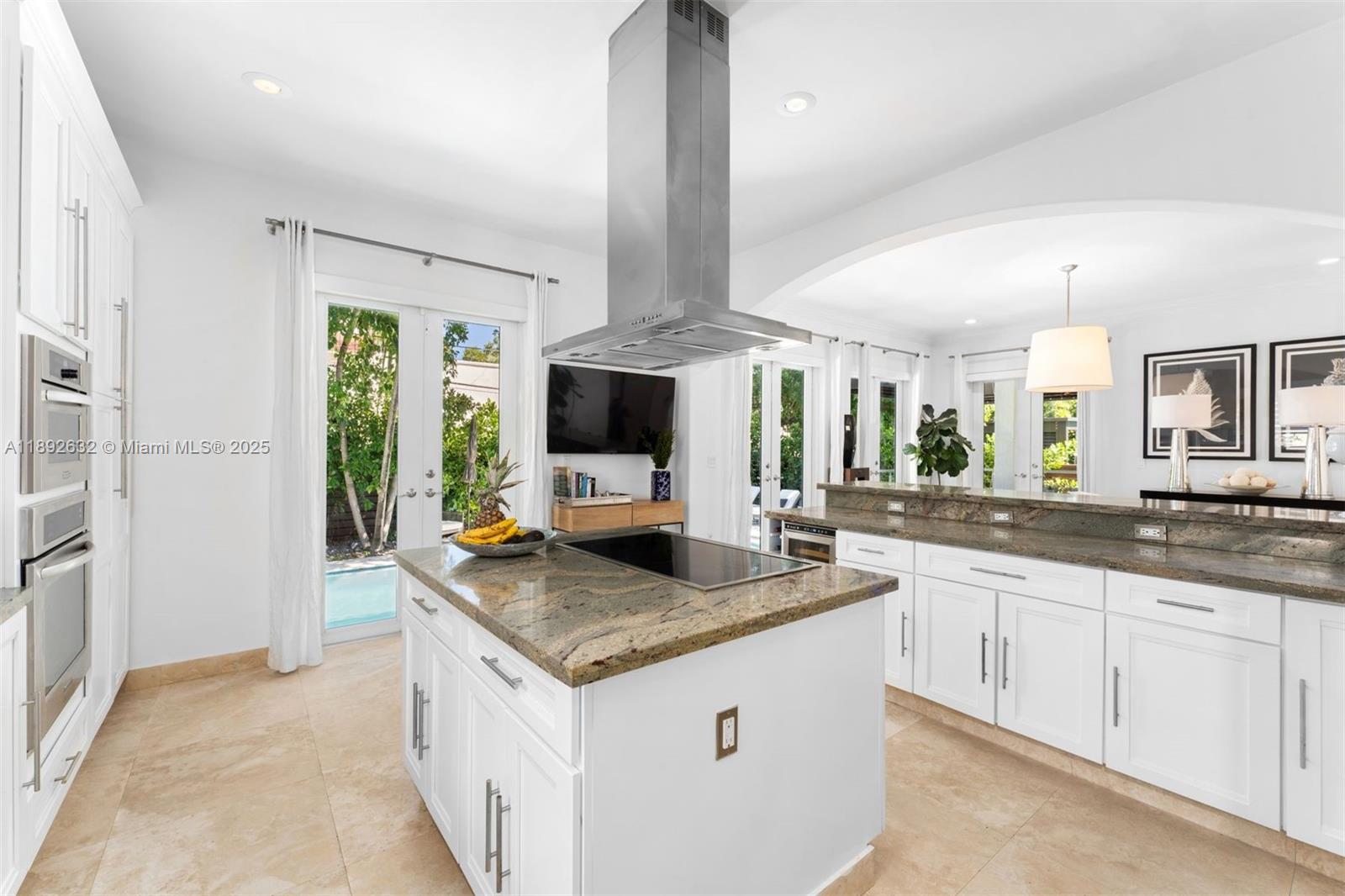 2143 North Bay Road Miami Beach, FL 33140 - Photo 12 of 39 a kitchen with granite countertop a sink and a stove top oven