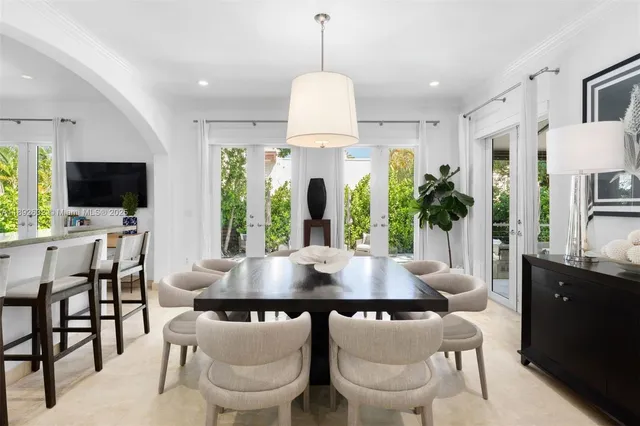 a dining room with furniture and a chandelier