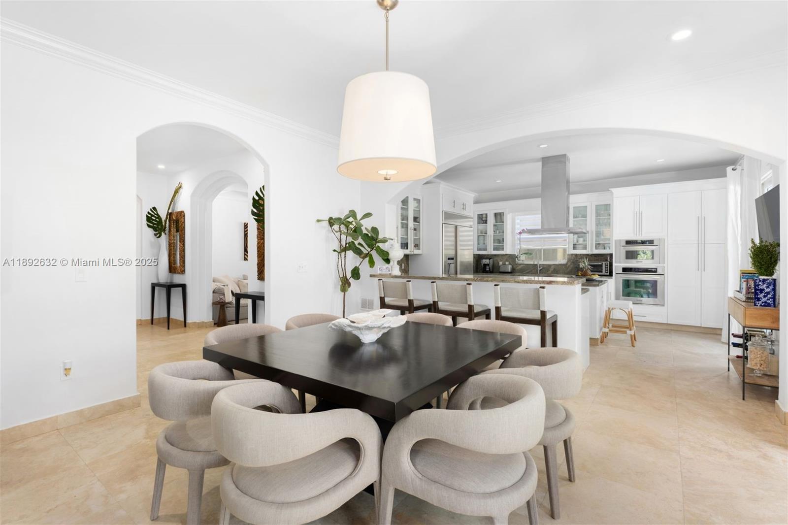 2143 North Bay Road Miami Beach, FL 33140 - Photo 15 of 39 a dining room with furniture and a chandelier