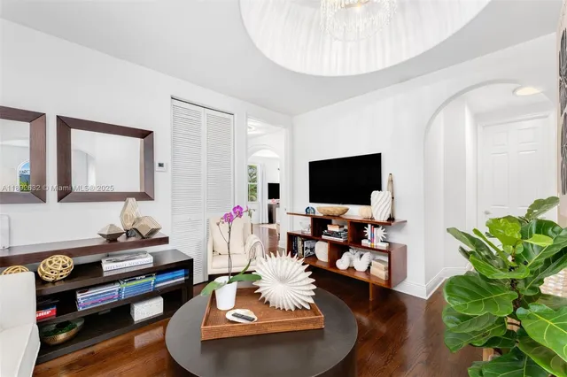 a spacious bedroom with a bed and a flat screen tv