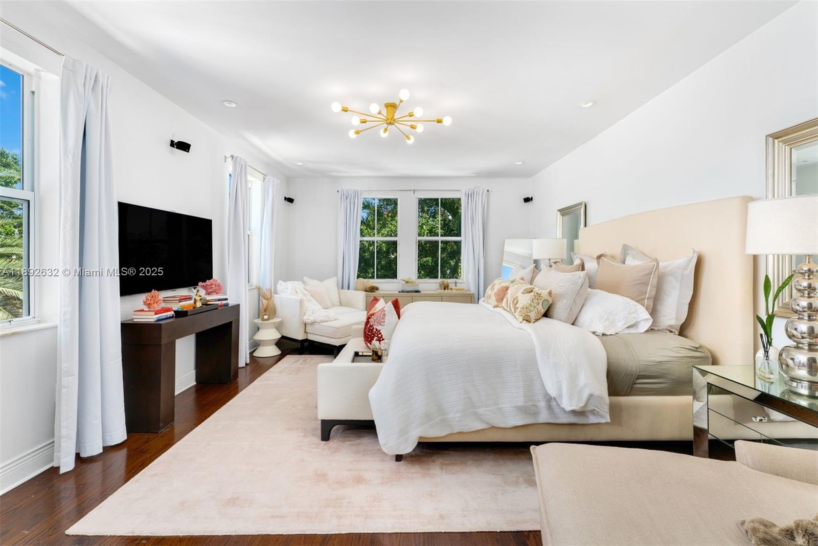 2143 North Bay Road Miami Beach, FL 33140 - Photo 23 of 39 a spacious bedroom with a bed and a flat screen tv