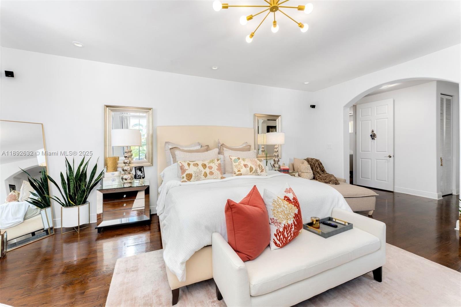 2143 North Bay Road Miami Beach, FL 33140 - Photo 24 of 39 a bedroom with a large bed and a chandelier