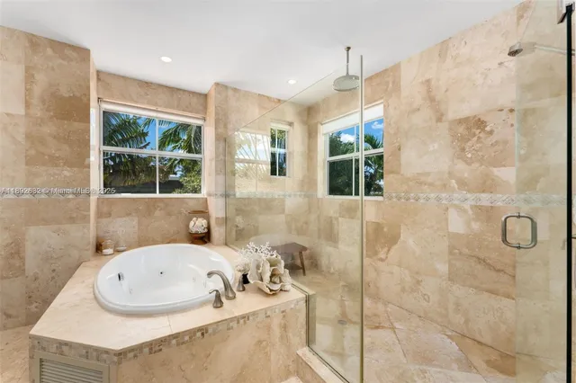 a spacious bathroom with a tub sink and mirror